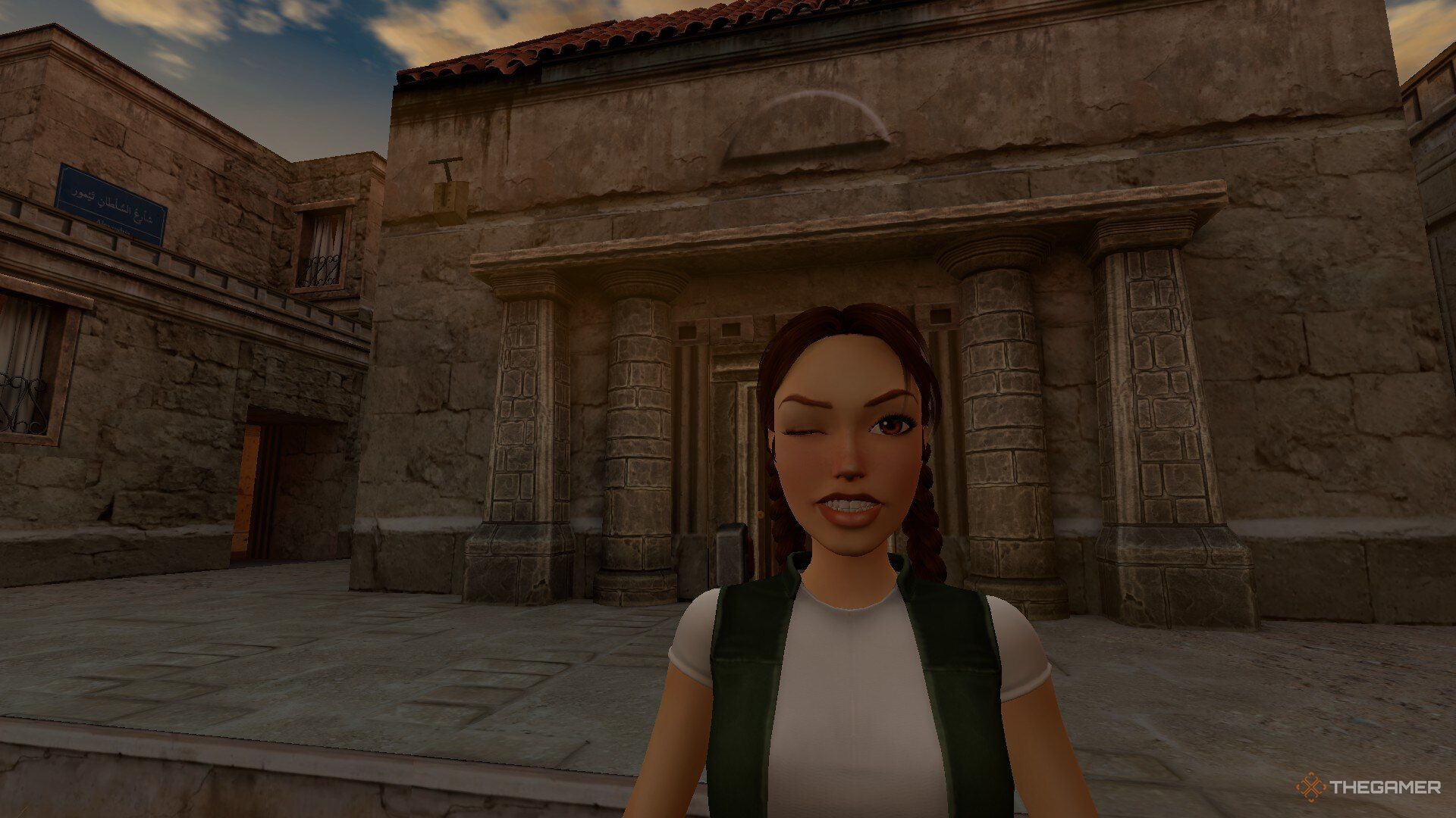 A young Lara winks at the camera in Alexandria in Tomb Raider: The Last Revelation.