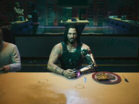 Cyberpunk 2077: Johnny Silverhand sits at a restaurant table with his hands together next to a plate of food