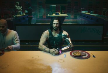 Cyberpunk 2077: Johnny Silverhand sits at a restaurant table with his hands together next to a plate of food