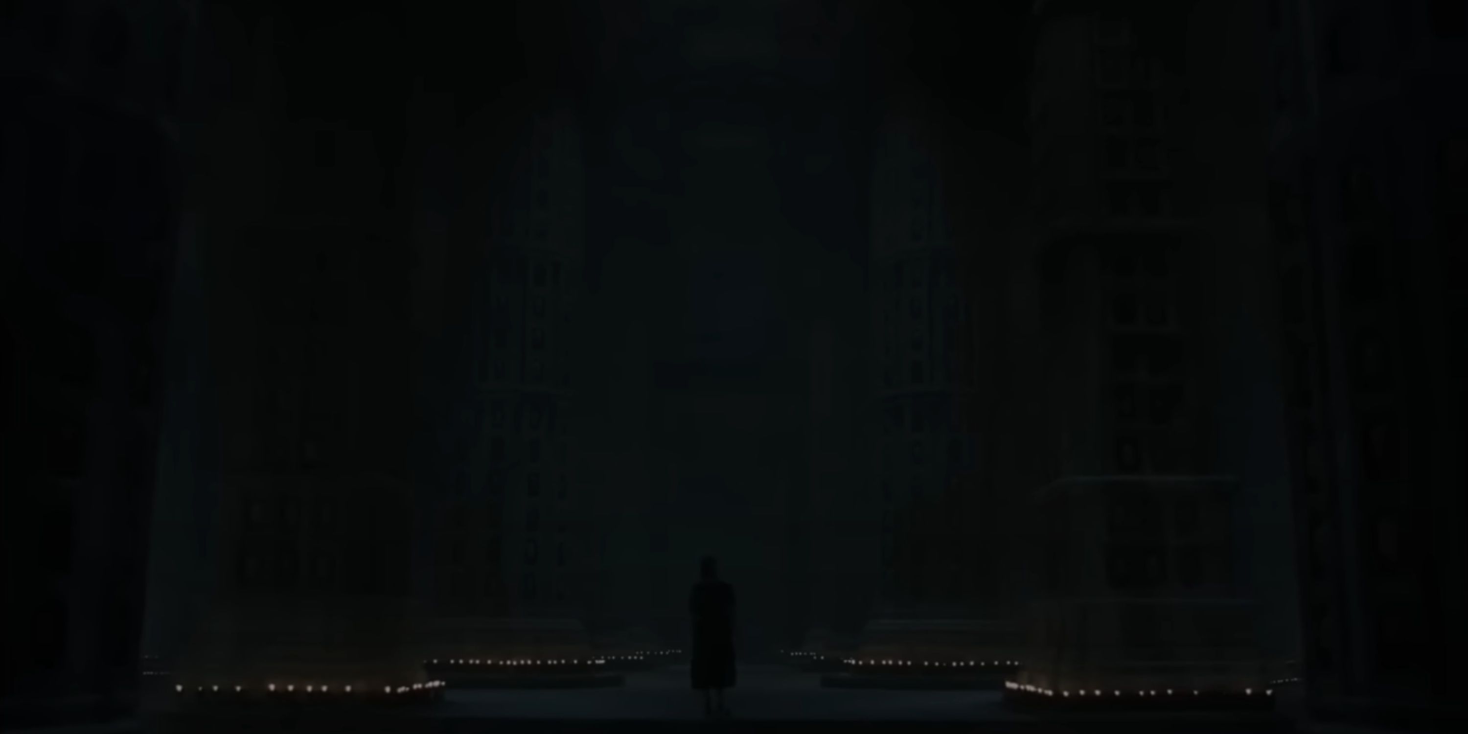 Arya stands at the centre of the Hall of Faces.