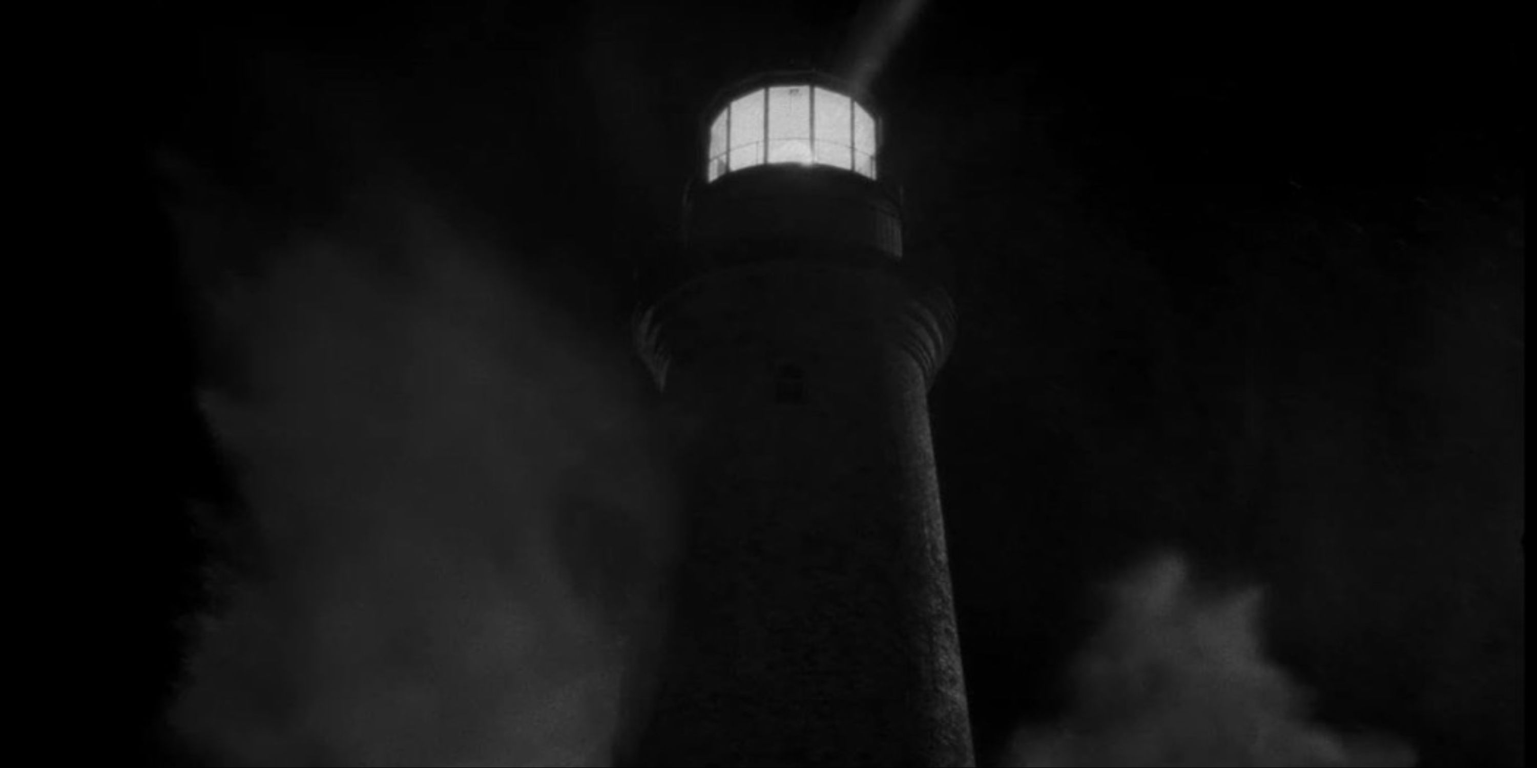 The Lighthouse - A close-up of a wave crashing over the lighthouse during the night.