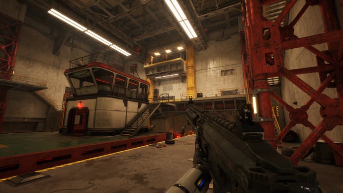 The interior of a hanger on a ship with a boat bobbing on an internal jetty. The player character holds a machine gun in their robotic hands.