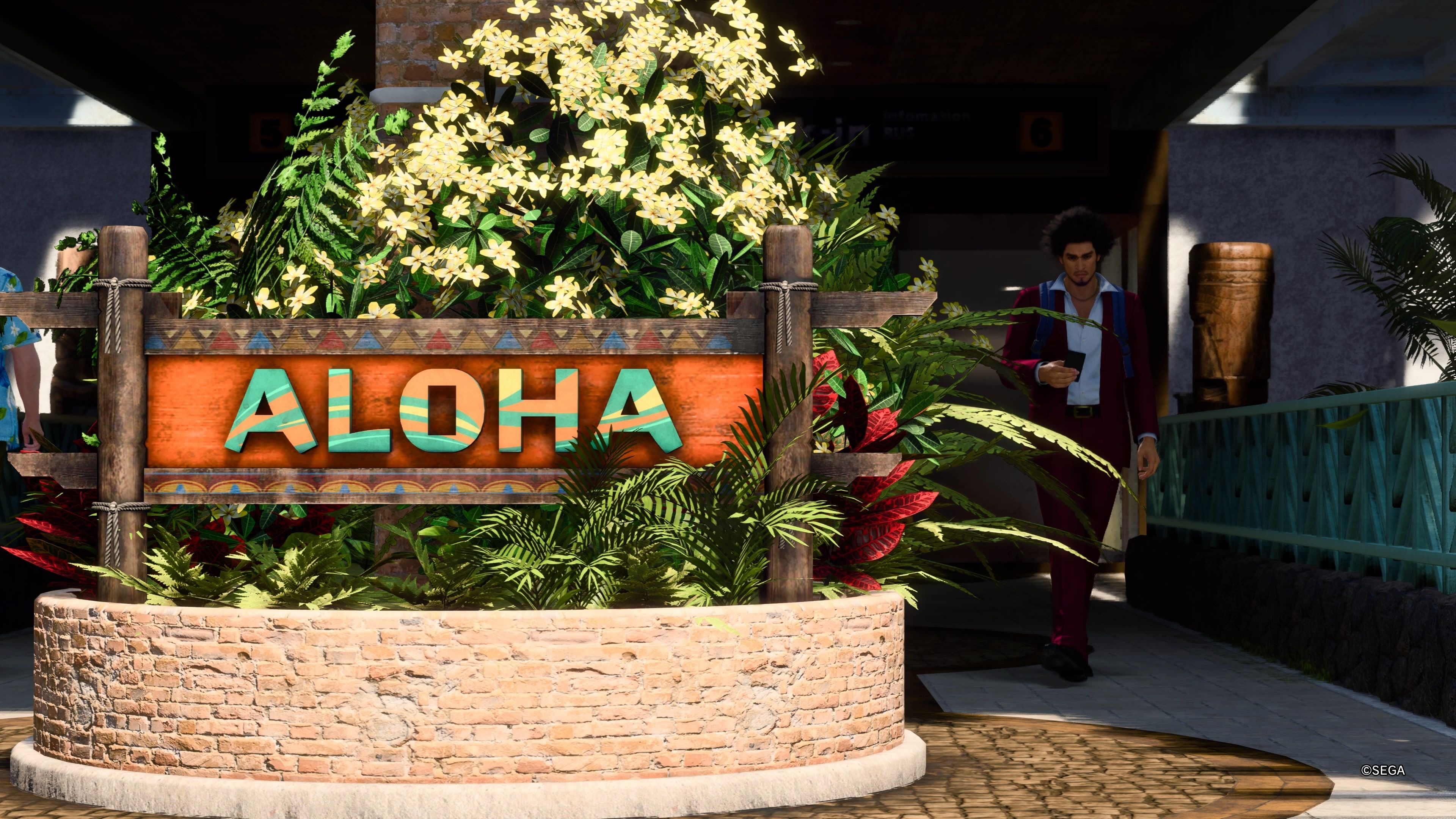 Kasuga walking past the Aloha sign as he arrives in Hawaii in like a Dragon Infinite Wealth.