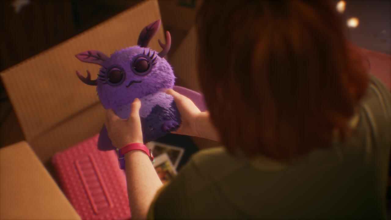 Swann holds her Moth Girl plushie.