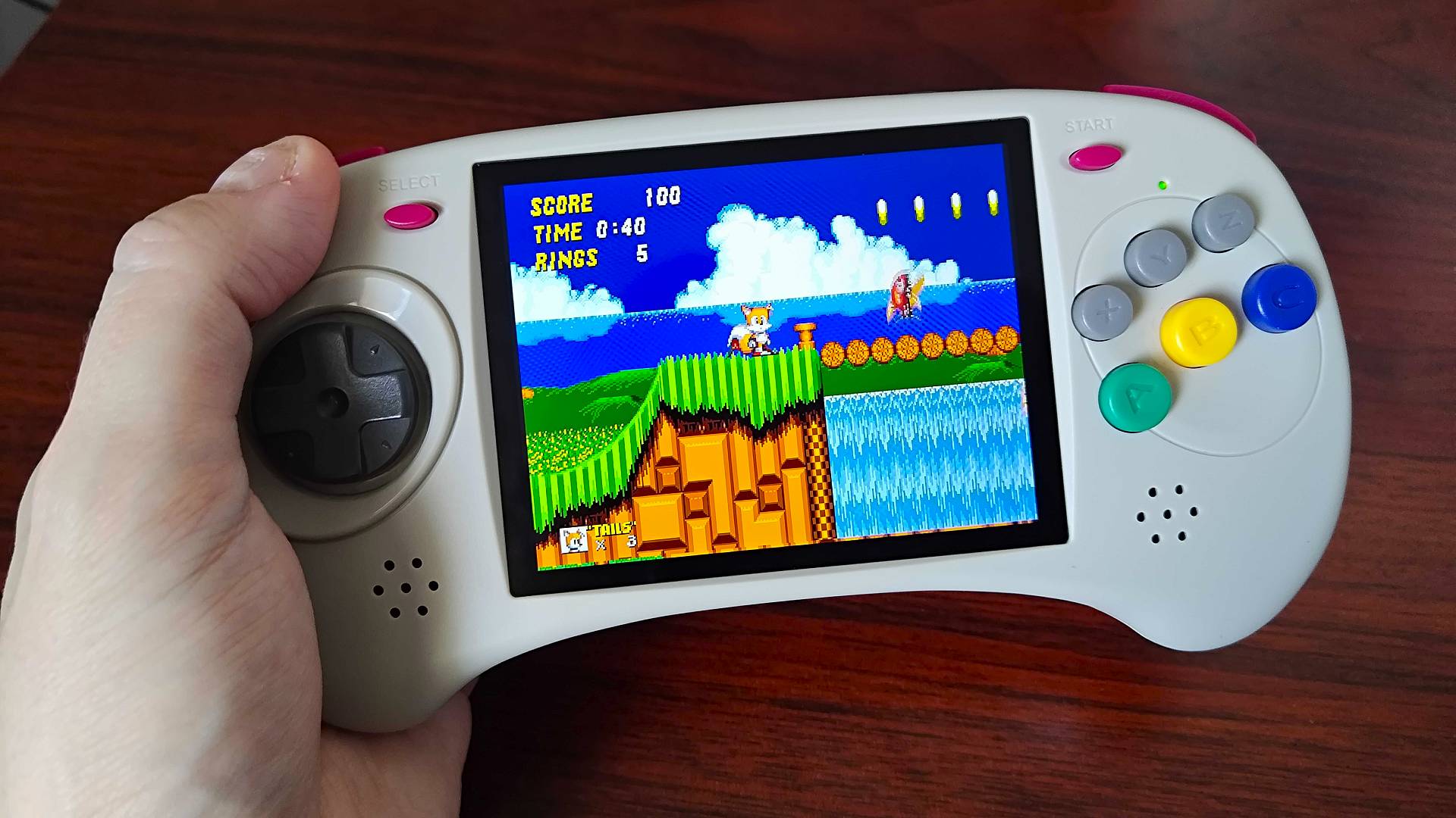 Anbernic RG ARC-D handheld with Sonic 2 gameplay on screen