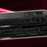 AMD Radeon RX 9070 and RX 9070 XT graphics cards stacked on top of each other with red backdrop