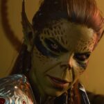 Baldur's Gate 3 screenshot showing Lae'zel, a Githyanki woman with olive green skin and tied-back red hair, smirking