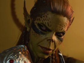 Baldur's Gate 3 screenshot showing Lae'zel, a Githyanki woman with olive green skin and tied-back red hair, smirking