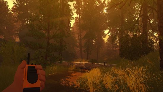 Best story games - a first-person view of an autumnal forest in Firewatch. A yellow walkie talkie is held by the protagonist.