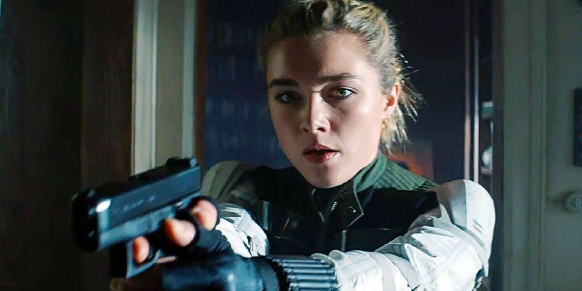 Yelena Belova aiming a gun in an apartment in Black Widow