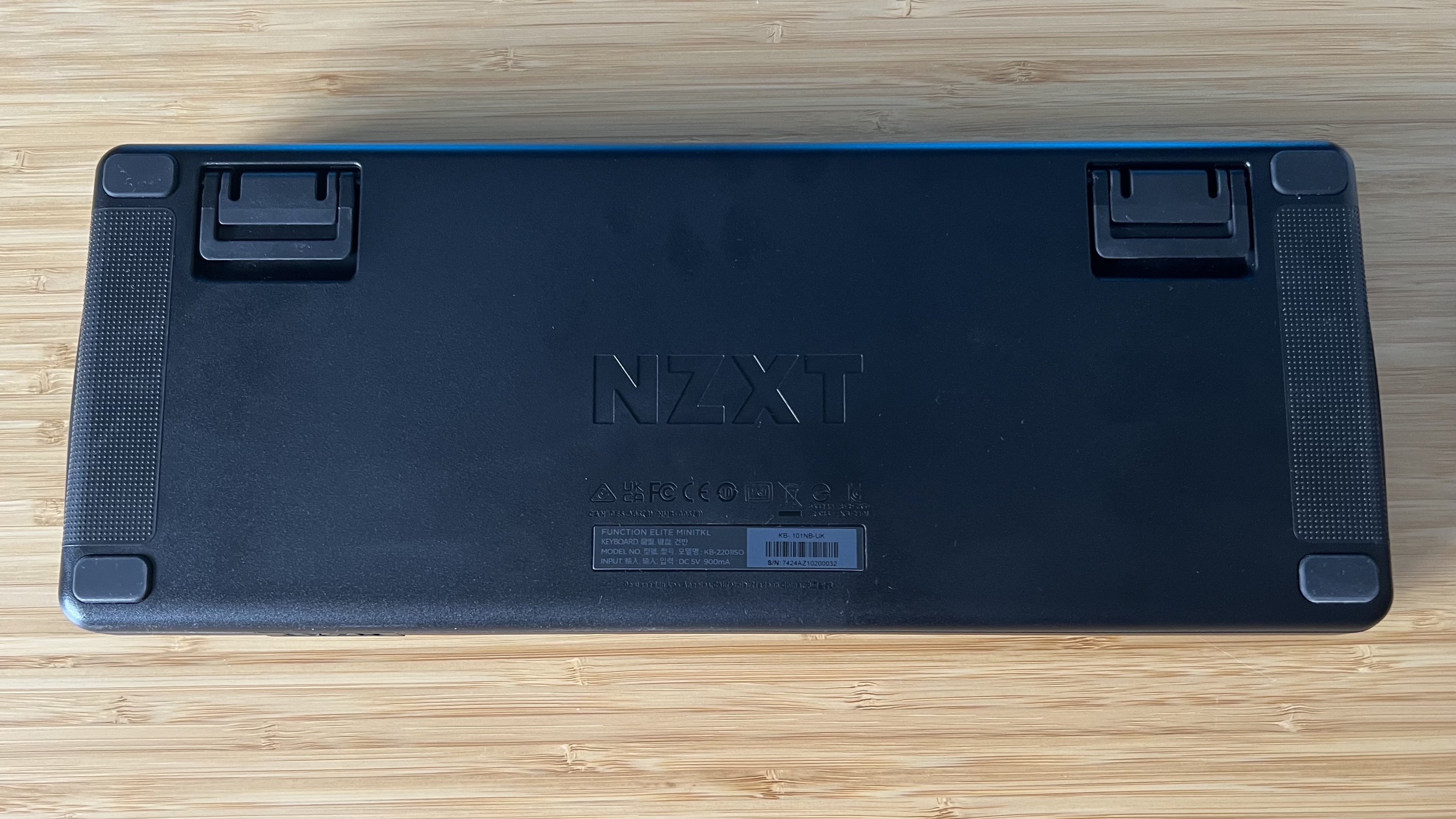 Back of NZXT Function Elite MiniTKL showing flippable feet and grippy texture