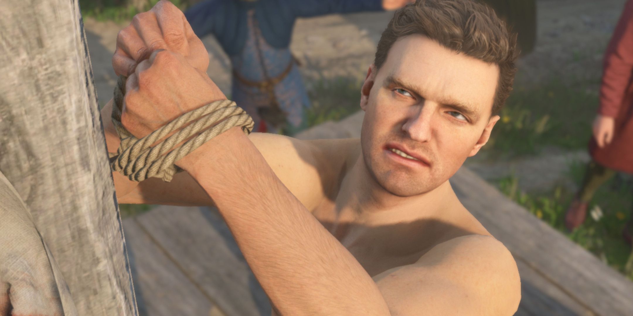 Henry tied to a post in Kingdom Come: Deliverance 2.