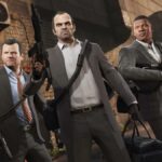 Three playable characters stand in a triangle wearing suits and holding guns in GTA 5