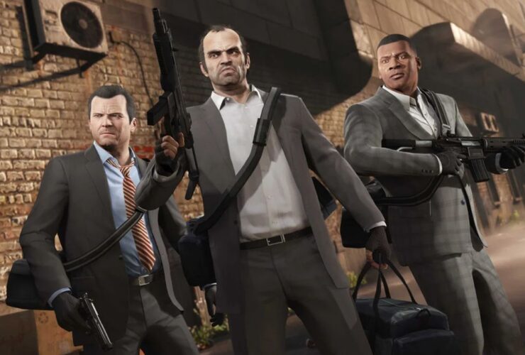 Three playable characters stand in a triangle wearing suits and holding guns in GTA 5