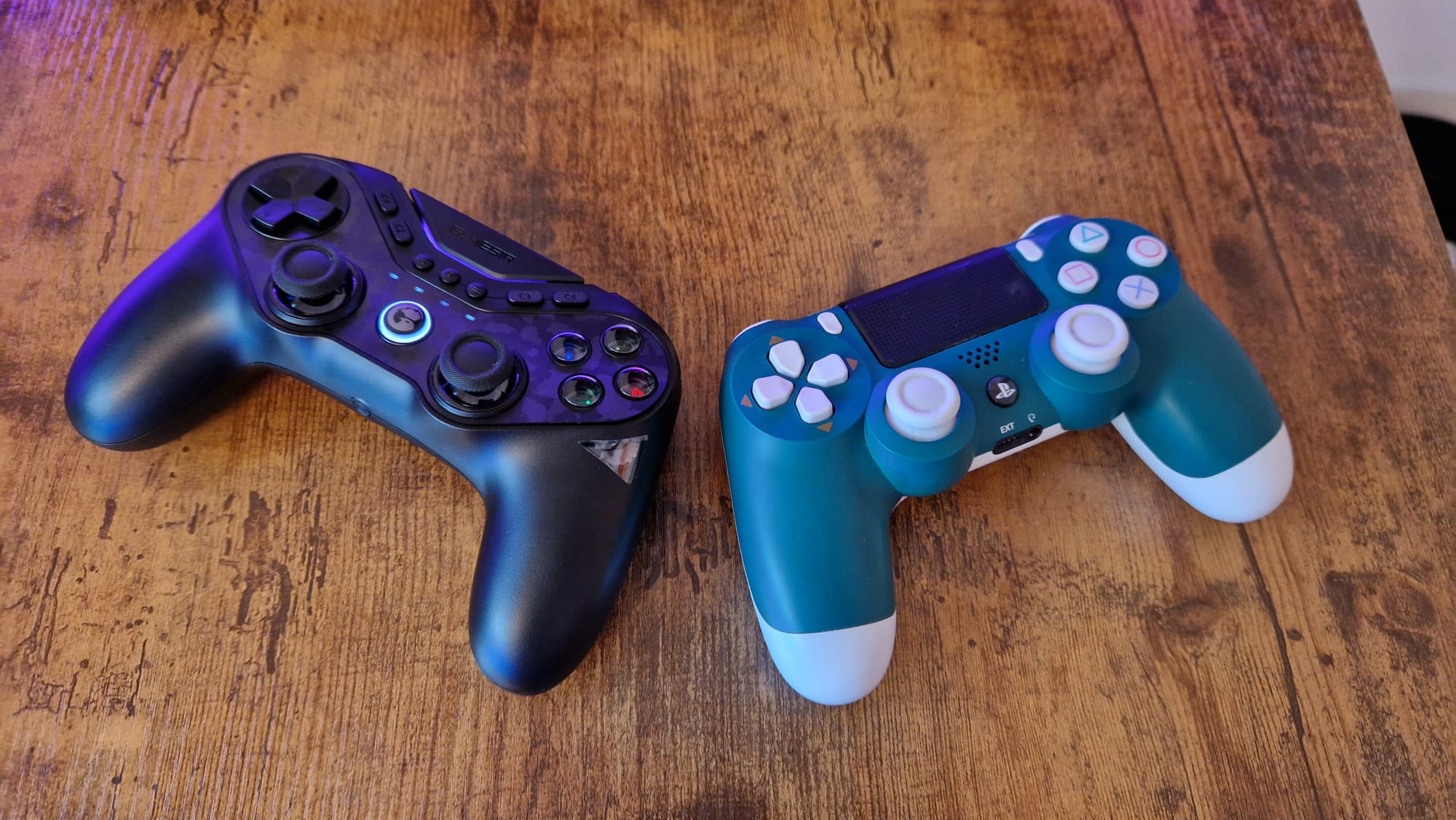 An Alpine Green DualShock 4 lying next to a GameSir Tarantula Pro