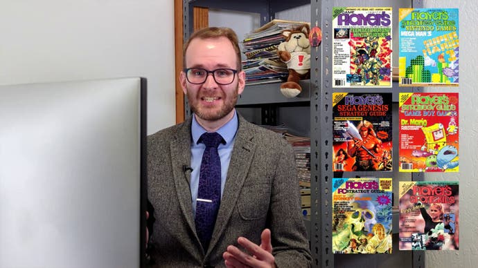 Phil Salvador of the video game history foundation stands to the left of a number of 1980s strategy guides.