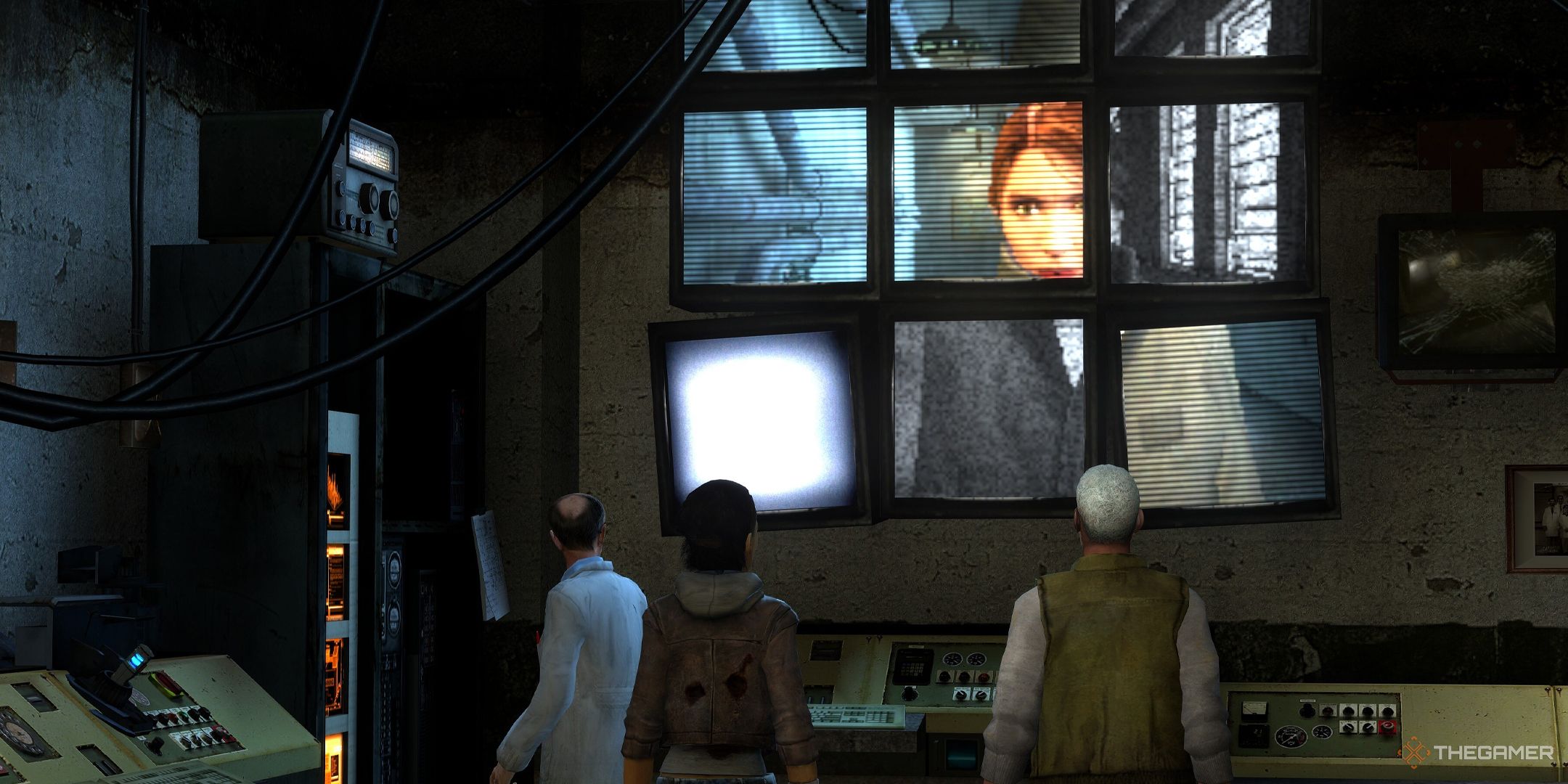Kleiner, Alyx, and Eli in Half-Life 2 Episode Two looking up at nine monitors displaying Judith Mossman in the Arctic.
