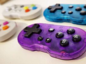 Photo by writer Rosalie Newcombe of a set of four ATOM controllers, with a focus on the Atomic Purple version and the others in the background.