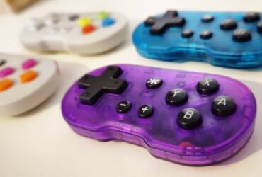 Photo by writer Rosalie Newcombe of a set of four ATOM controllers, with a focus on the Atomic Purple version and the others in the background.