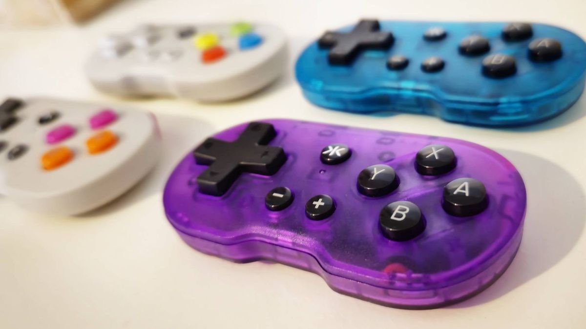 Photo by writer Rosalie Newcombe of a set of four ATOM controllers, with a focus on the Atomic Purple version and the others in the background.