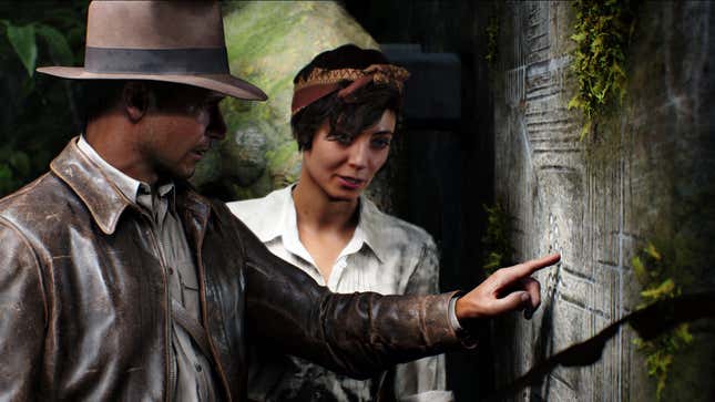 Indiana Jones points to a diagram on the wall while standing next to a fellow adventurer.