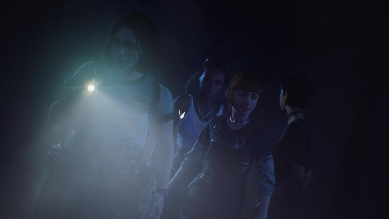 Swann records in the dark while Kat, Nora, and Autumn stand behind her.