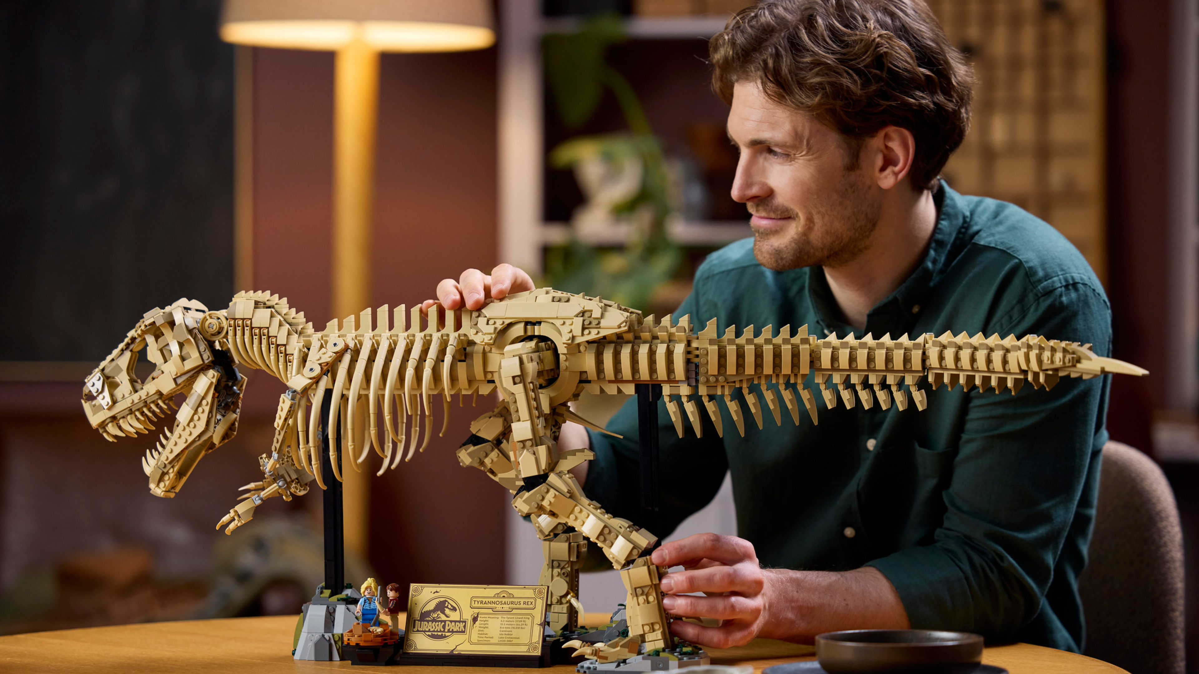 A man looking incredibly pleased with his Lego Jurassic World T-Rex