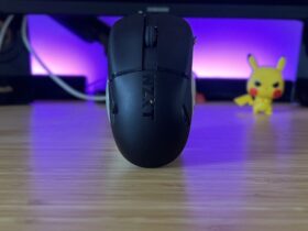 NZXT Lift Elite Wireless gaming mouse on a standing upright on a wooden gaming desk with purple lighting