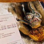 The Monster Manual Spectator artwork and stat block, lying against a wooden surface