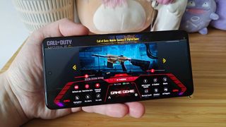 Asus ROG Phone 9 Pro with Game Genie overlay displayed