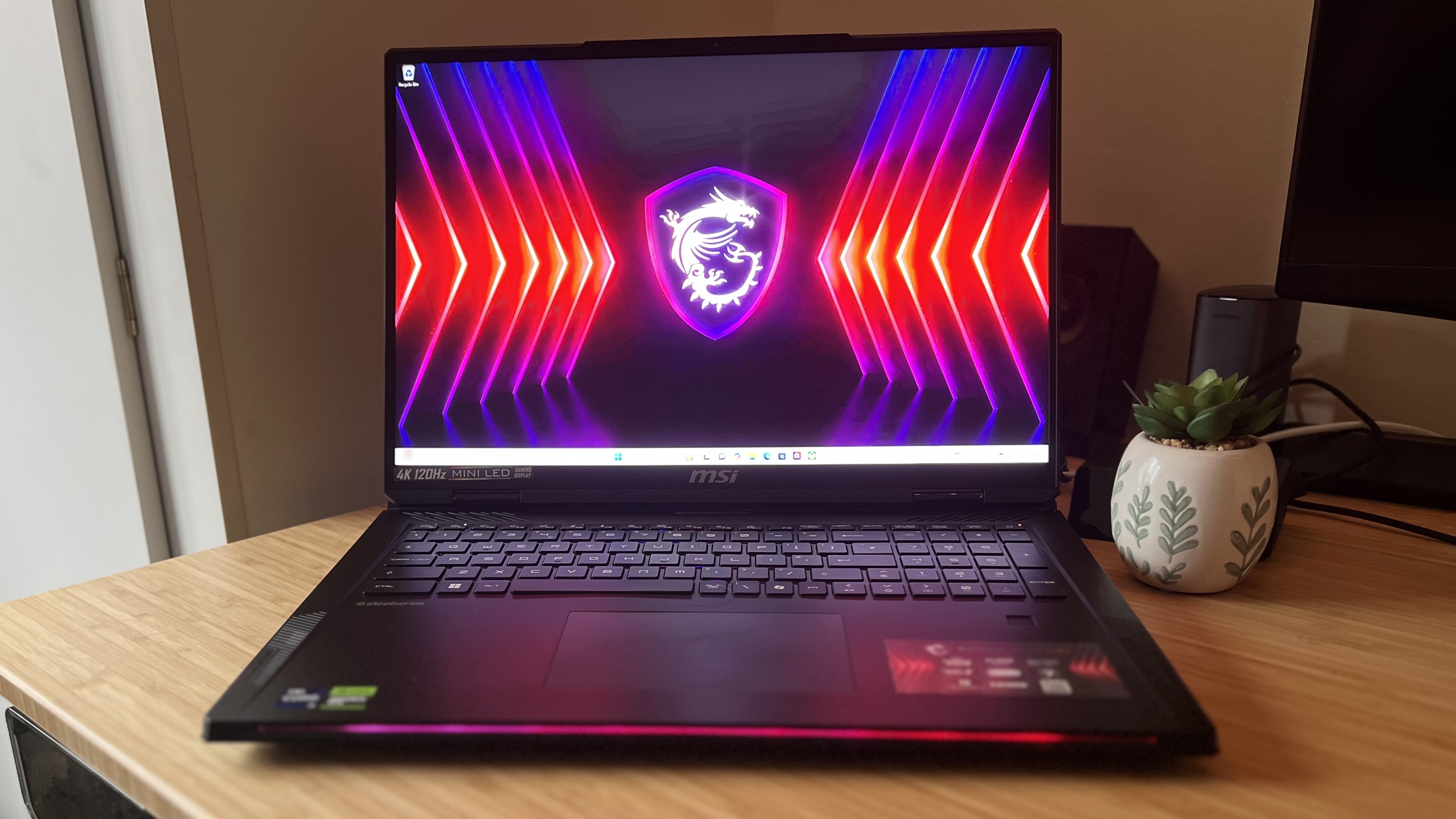 MSI Raider 18 HX laptop on desktop screen on a wooden desk