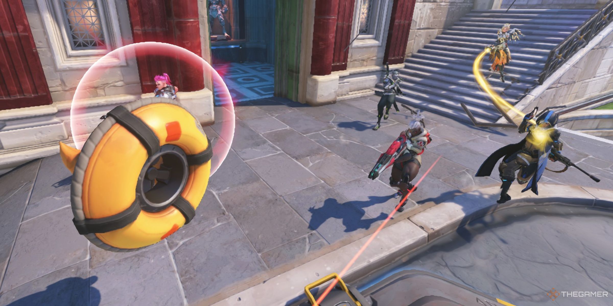 A Junkrat RIP-Tire Using The Nitro Boost Perk To Rush Towards A Team Of Sojourn, Zarya, Mercy, Ana, And Genji In Overwatch 2.