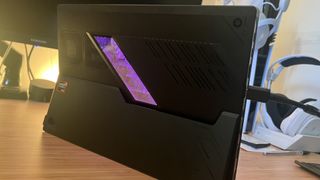 Rear panel of Asus ROG Flow Z13 with purple RGB enabled on window portion