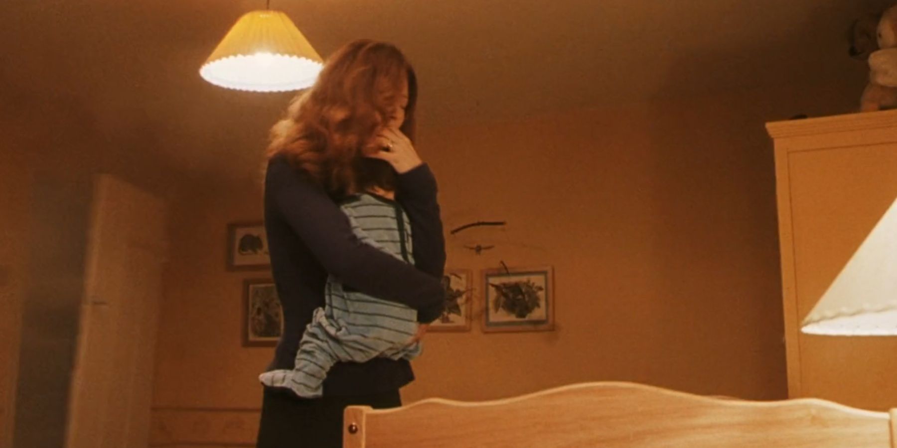 Lily Potter holds infant Harry in Harry Potter and the Sorcerer's Stone.