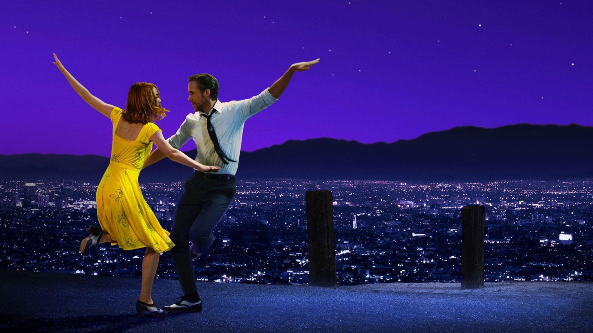 Ryan Gosling and Emma Stone dancing on a rooftop in la la land's poster.