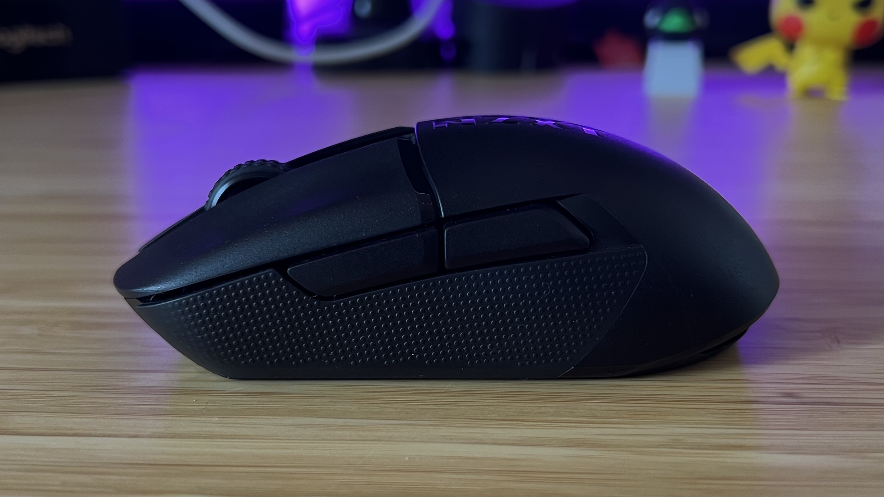 Side view of NZXT Lift Elite Wireless gaming mouse showing rubber side grips and buttons