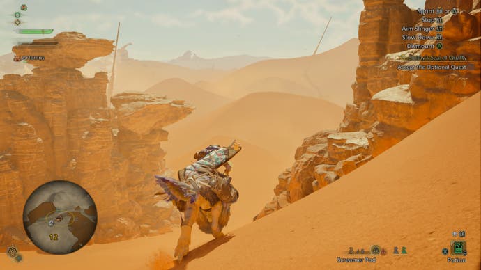 A hunter crests tall sand dunes on a Seikret in Monster Hunter Wilds.