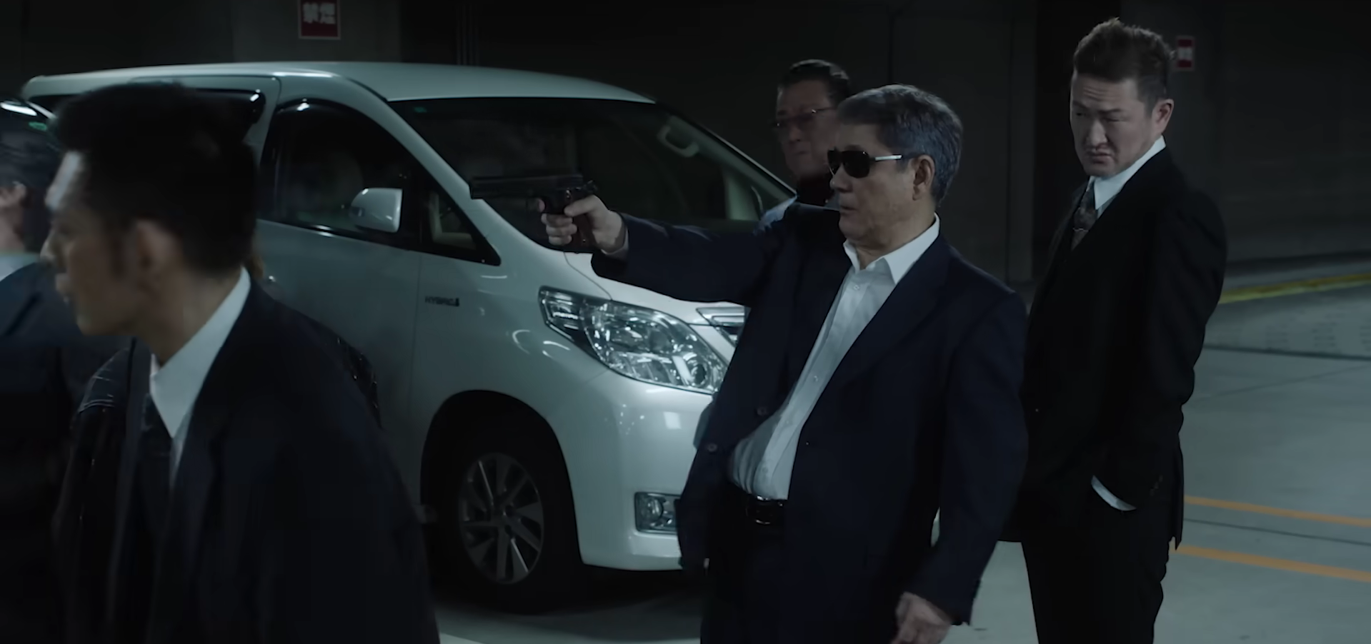 Takeshi Kitano firing a gun in Broken Rage.