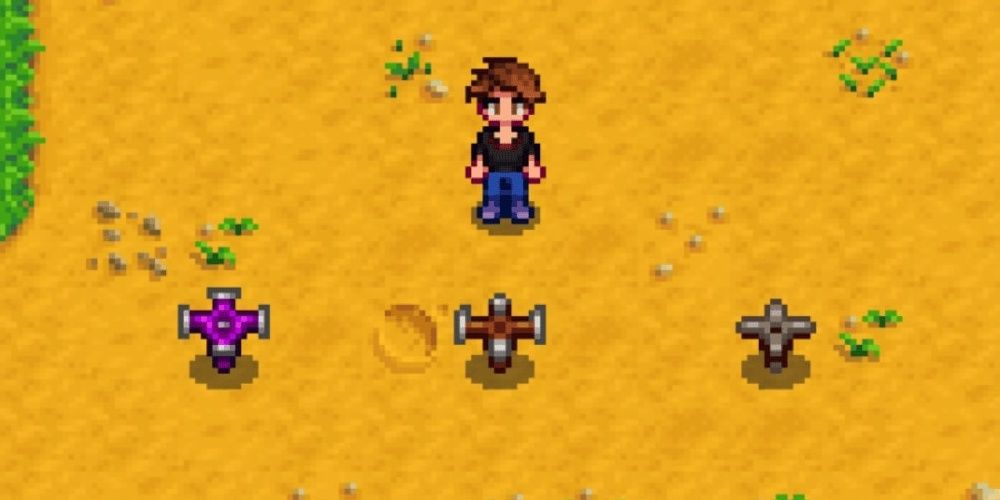 A sprinkler, quality sprinkler, and iridium sprinkler presented by a farmer in Stardew Valley the video game