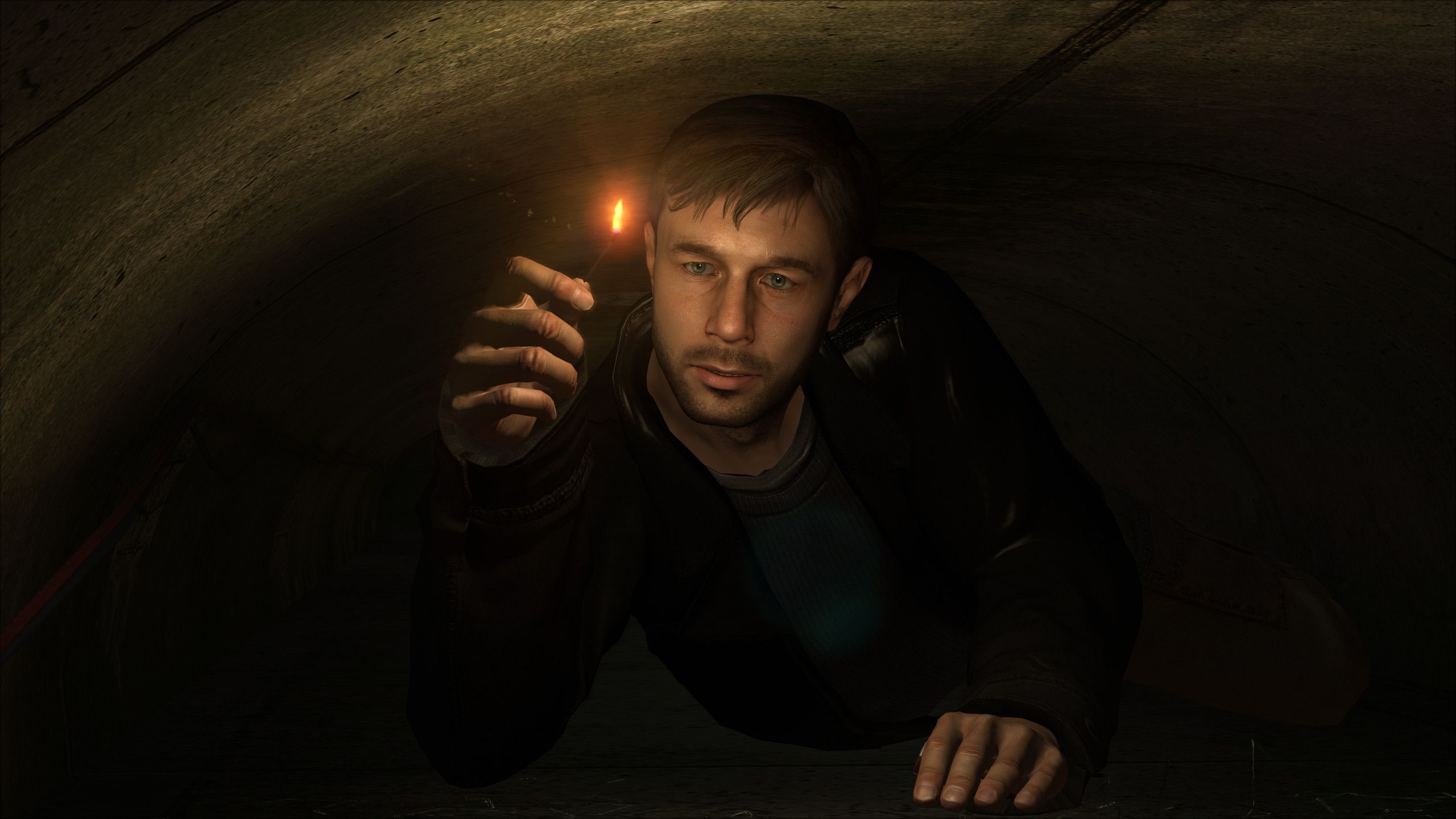 Ethan Mars holds a match while crawling through a tunnel in Heavy Rain. 