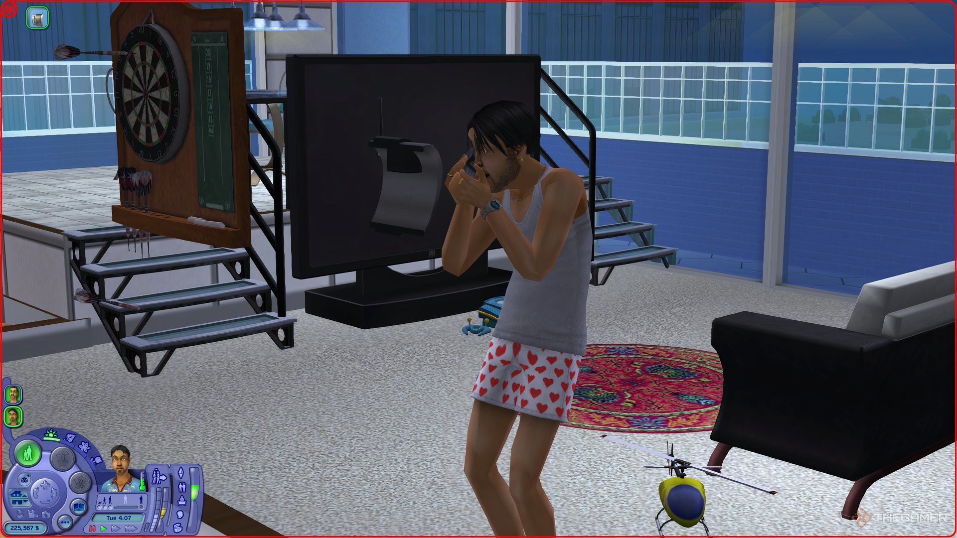 A panicked Sim in The Sims 2 making a phonecall to emergency services.