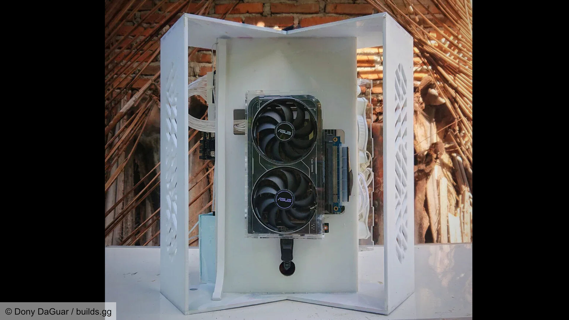 Futuristic space-like gaming PC build, internal section showing the graphics card and GPU riser cable.