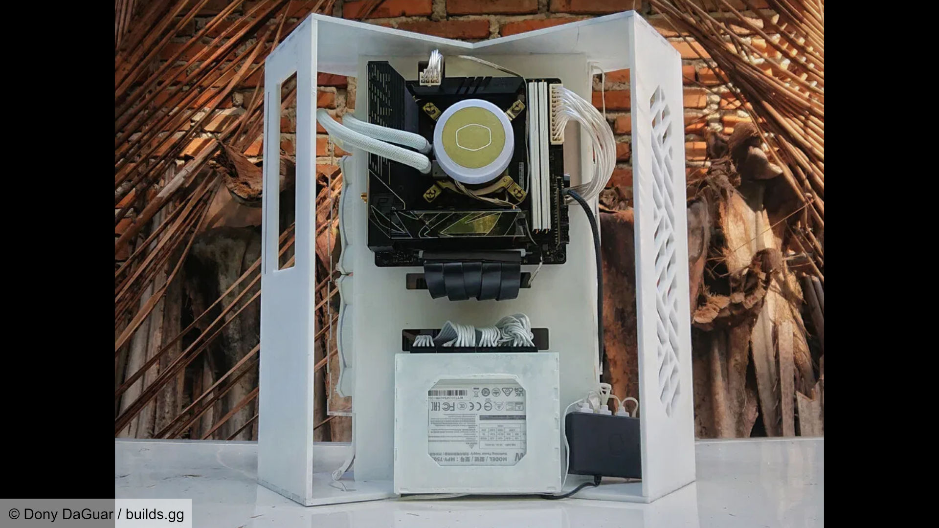 Futuristic space-like gaming PC build, internal section showing motherboard and power supply.