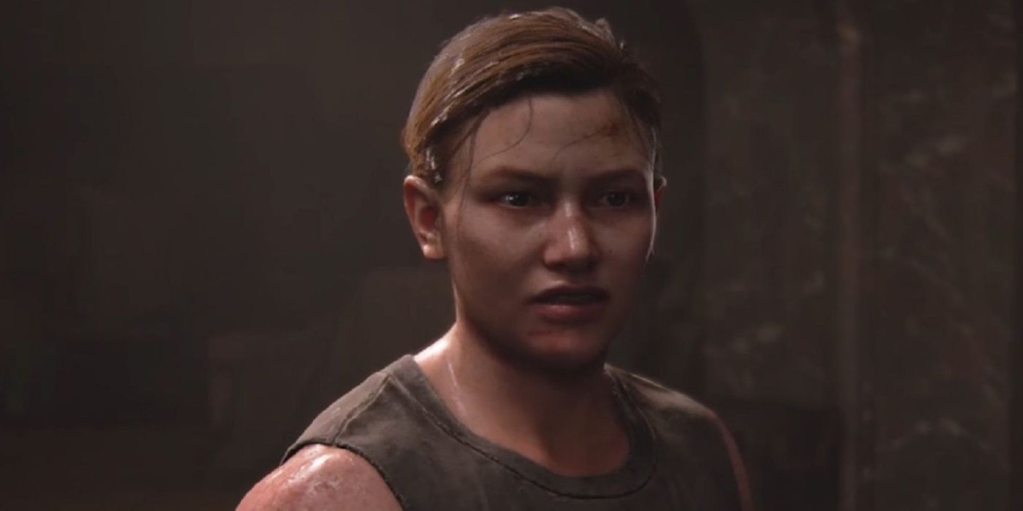 A close up shot of Abby in The Last of Us Part 2 against a plain background.