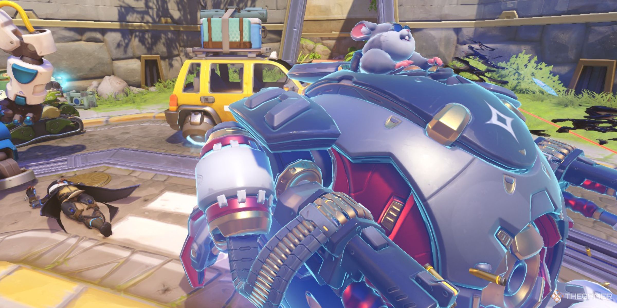 Wrecking Ball Using His Adaptive Shield To Protect Himself While A Teammate Ana Is Lying Dead Behind Him In Overwatch 2.