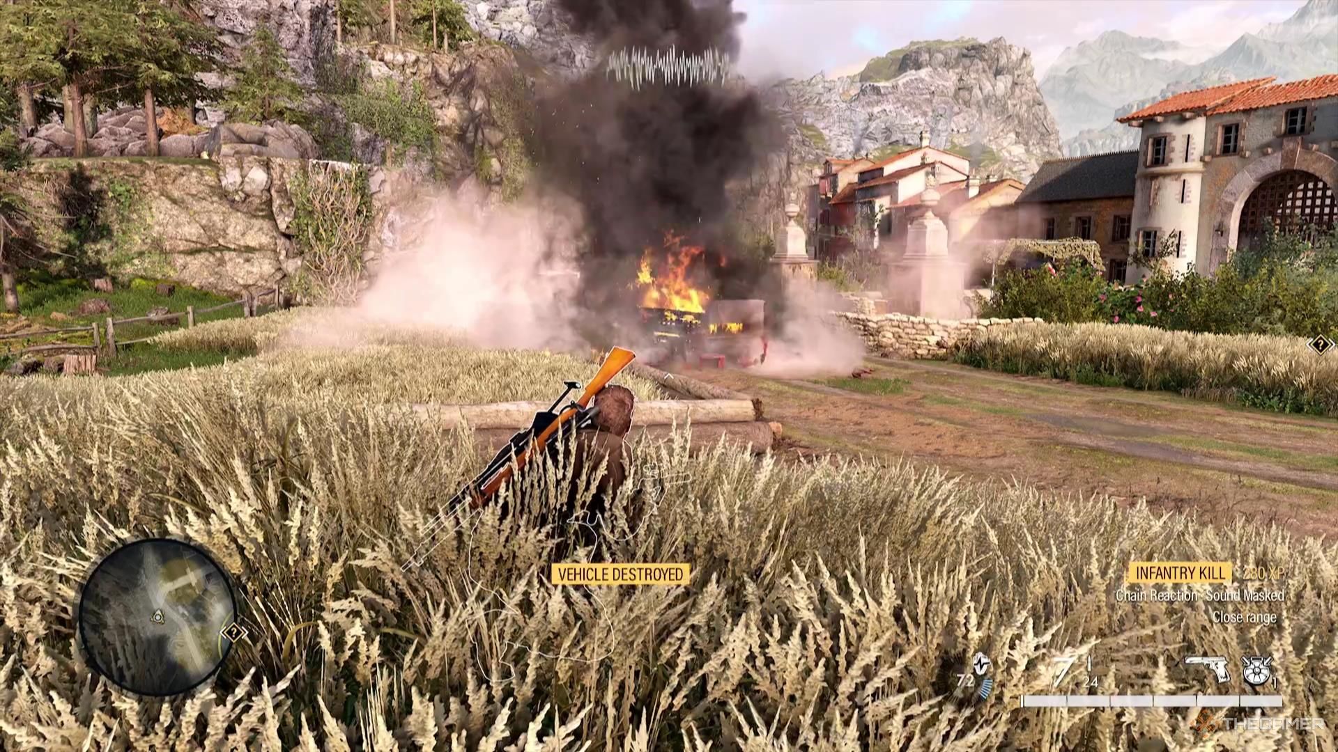A burning wreck of a vehicle sits in the road in Sniper Elite Resistance.