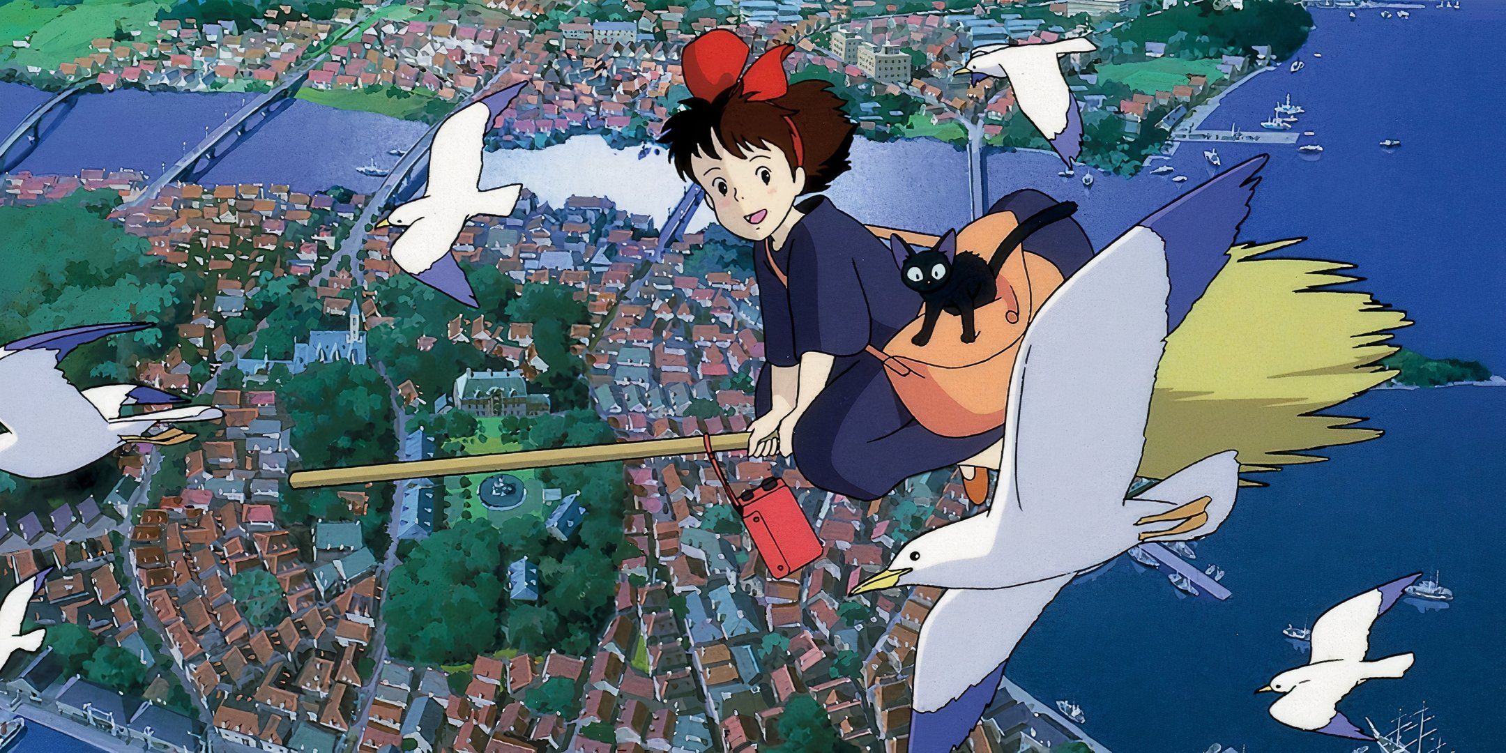 Kiki flying over a coastal city while surrounded by sea gulls.