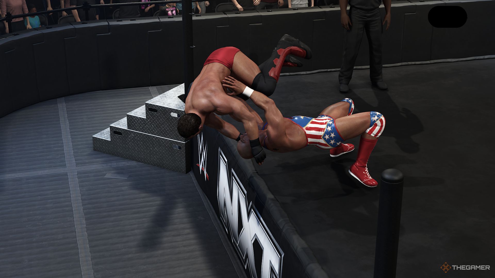 WWE 2K25 screenshot of Kurt Angle suplexing Ken Shamrock out of the ring.