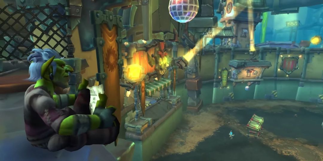 A Goblin reads a book while sitting on a ledge.