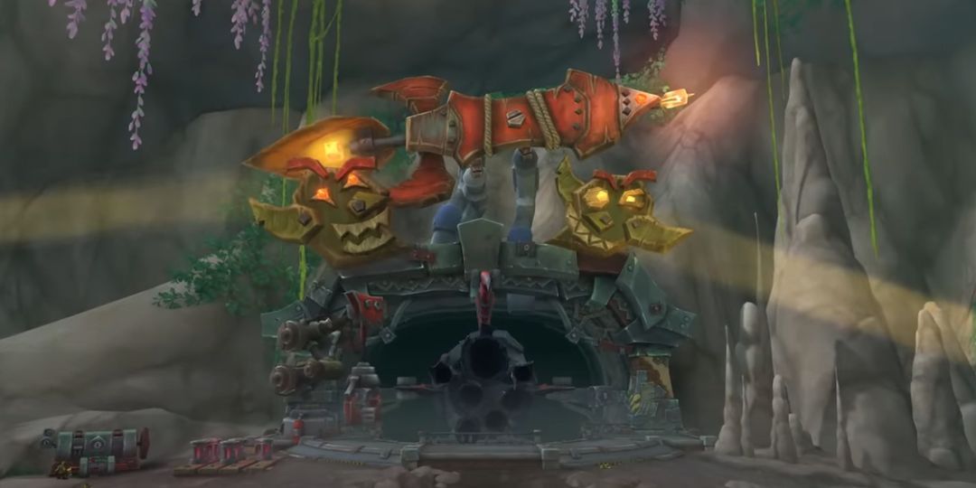 Two statues of Goblins stand next to a rocket.